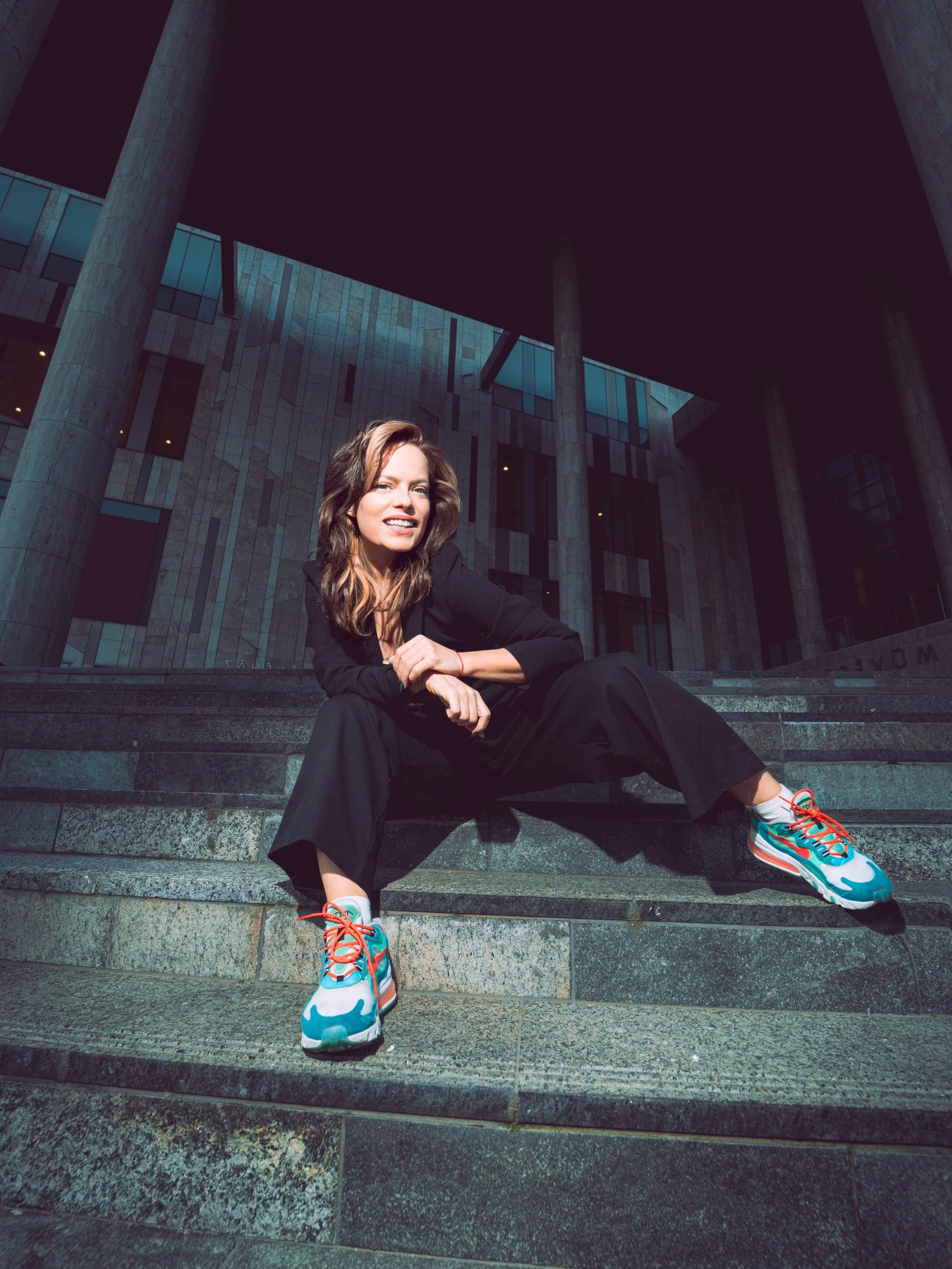 Timea Papp seated on architectural steps